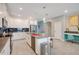 Modern kitchen with white cabinets, gray countertops, and stainless steel appliances at 1179 Kingsbarn St, Davenport, FL 33896