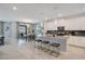 Open concept kitchen with island, white cabinets, and gray countertops at 1179 Kingsbarn St, Davenport, FL 33896