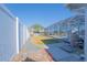 Landscaped backyard leading to enclosed pool area and scenic waterway views at 136 Reef Rd, South Daytona, FL 32119