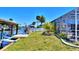 Backyard boasts lush landscaping, dock, and pool enclosure, creating a perfect waterfront oasis for relaxation and recreation at 136 Reef Rd, South Daytona, FL 32119