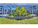 Landscaped backyard featuring a screened-in pool area, lush greenery, and a well-maintained lawn at 136 Reef Rd, South Daytona, FL 32119