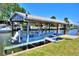 Covered boat dock with boat, set on a waterfront canal at 136 Reef Rd, South Daytona, FL 32119