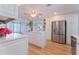 Bright kitchen with white cabinetry, kitchen island, stainless steel appliances, and ample counter space at 136 Reef Rd, South Daytona, FL 32119