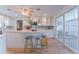 Bright kitchen featuring white cabinetry, kitchen island, stainless steel appliances, and a breakfast bar at 136 Reef Rd, South Daytona, FL 32119