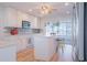 Bright kitchen featuring white cabinetry, an island, stainless steel appliances, and modern flooring at 136 Reef Rd, South Daytona, FL 32119