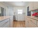 Bright kitchen featuring stainless steel appliances, white cabinetry, and a stylish backsplash at 136 Reef Rd, South Daytona, FL 32119