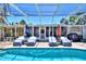 Inviting backyard pool with covered patio area and lounge chairs at 136 Reef Rd, South Daytona, FL 32119