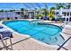 Outdoor pool area with dining and entertainment space, featuring a large pool and hot tub at 136 Reef Rd, South Daytona, FL 32119
