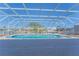 Enclosed pool area with ample lounging space and a view of the surrounding waterways at 136 Reef Rd, South Daytona, FL 32119