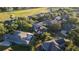 Sun-drenched aerial view of homes nestled among trees, showcasing the neighborhood's serene setting at 1912 Westover Reserve Blvd, Windermere, FL 34786