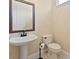 Powder room with pedestal sink, toilet, and decorative wallpaper at 1912 Westover Reserve Blvd, Windermere, FL 34786