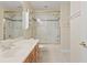 Bathroom featuring a vanity and a glass-enclosed shower and tub combo at 1912 Westover Reserve Blvd, Windermere, FL 34786