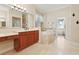 Elegant bathroom features a soaking tub, vanity with sink, and travertine tile flooring at 1912 Westover Reserve Blvd, Windermere, FL 34786