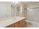 Well-lit bathroom features a vanity and a glass-enclosed shower and tub combo at 1912 Westover Reserve Blvd, Windermere, FL 34786