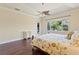 Bright bedroom features a ceiling fan and large window overlooking lush greenery at 1912 Westover Reserve Blvd, Windermere, FL 34786