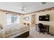 Bright bedroom featuring a ceiling fan, desk, and ensuite bathroom at 1912 Westover Reserve Blvd, Windermere, FL 34786