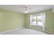Green bedroom is illuminated by natural light streaming through a large window at 1912 Westover Reserve Blvd, Windermere, FL 34786