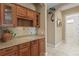Butler's pantry with granite countertop and wood cabinets, perfect for entertaining at 1912 Westover Reserve Blvd, Windermere, FL 34786