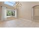 Airy dining room with a chandelier and large window with backyard views at 1912 Westover Reserve Blvd, Windermere, FL 34786