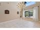 Bright dining room with a chandelier and large windows overlooking the backyard at 1912 Westover Reserve Blvd, Windermere, FL 34786