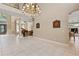 Spacious foyer with a chandelier and grand staircase, adjacent to the living room at 1912 Westover Reserve Blvd, Windermere, FL 34786