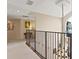 Hallway with wrought iron railing and chandelier at 1912 Westover Reserve Blvd, Windermere, FL 34786