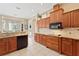 Traditional kitchen with wood cabinets, granite countertops, and modern appliances at 1912 Westover Reserve Blvd, Windermere, FL 34786