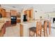 Open-concept kitchen featuring granite countertops, breakfast bar, and wooden cabinetry at 1912 Westover Reserve Blvd, Windermere, FL 34786