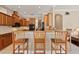 Kitchen view with bar seating overlooking granite countertops and wood cabinets at 1912 Westover Reserve Blvd, Windermere, FL 34786