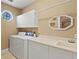 Spacious laundry room with white cabinets, sink, and modern washer and dryer at 1912 Westover Reserve Blvd, Windermere, FL 34786