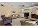 Comfortable living room with fireplace, built-in shelves, and ceiling fan at 1912 Westover Reserve Blvd, Windermere, FL 34786