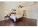 Serene main bedroom featuring hardwood floors, a tray ceiling, and an ensuite bathroom at 1912 Westover Reserve Blvd, Windermere, FL 34786
