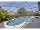 Sparkling screened-in pool and spa area with mature landscaping creates a private oasis at 1912 Westover Reserve Blvd, Windermere, FL 34786