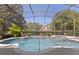 The screened-in pool boasts a lush backyard view and seamlessly integrates with the spa at 1912 Westover Reserve Blvd, Windermere, FL 34786