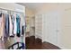 Spacious walk-in closet with custom shelving and organizers for clothes and accessories at 1912 Westover Reserve Blvd, Windermere, FL 34786