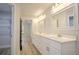 Bathroom with double vanity, quartz countertop, and white cabinets at 335 Vincent Dr, Mount Dora, FL 32757