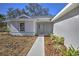 Front view of a new house with a light green door and walkway at 335 Vincent Dr, Mount Dora, FL 32757