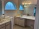 Bathroom with double vanity, marble countertop and large mirror at 17353 Chateau Pine Way, Clermont, FL 34711