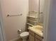 Simple bathroom with vanity, toilet, and shelving unit at 17353 Chateau Pine Way, Clermont, FL 34711