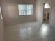 Spacious bedroom with light pink walls and wood-look flooring at 17353 Chateau Pine Way, Clermont, FL 34711