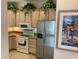Kitchen boasts stainless steel appliances and light wood cabinets at 17353 Chateau Pine Way, Clermont, FL 34711
