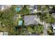 Aerial view of a home showcasing its roof, landscaped yard, pool, and neighborhood at 2161 Sharon Rd, Winter Park, FL 32789
