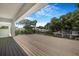 Spacious back porch featuring wood flooring, a glass railing, and a view of the neighborhood at 2161 Sharon Rd, Winter Park, FL 32789