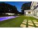 Expansive backyard with an inviting pool, cabana, outdoor kitchen, and meticulously maintained lawn at 2161 Sharon Rd, Winter Park, FL 32789