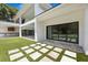 Stunning outdoor space with an outdoor kitchen, manicured lawn, and sleek design, perfect for entertaining at 2161 Sharon Rd, Winter Park, FL 32789