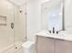 Modern bathroom featuring a vanity, toilet, and a glass enclosed shower with unique tiling at 2161 Sharon Rd, Winter Park, FL 32789