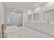 Modern bathroom featuring a soaking tub, double vanity, and glass-enclosed shower with marble tile at 2161 Sharon Rd, Winter Park, FL 32789