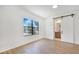 Bright bedroom with a barn door leading to the bathroom and a view of the backyard through the window at 2161 Sharon Rd, Winter Park, FL 32789