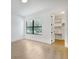 Bedroom with hardwood floors, large window, and a walk-in closet at 2161 Sharon Rd, Winter Park, FL 32789