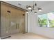 Elegant dining area featuring a striking chandelier, accent wall, and natural light at 2161 Sharon Rd, Winter Park, FL 32789